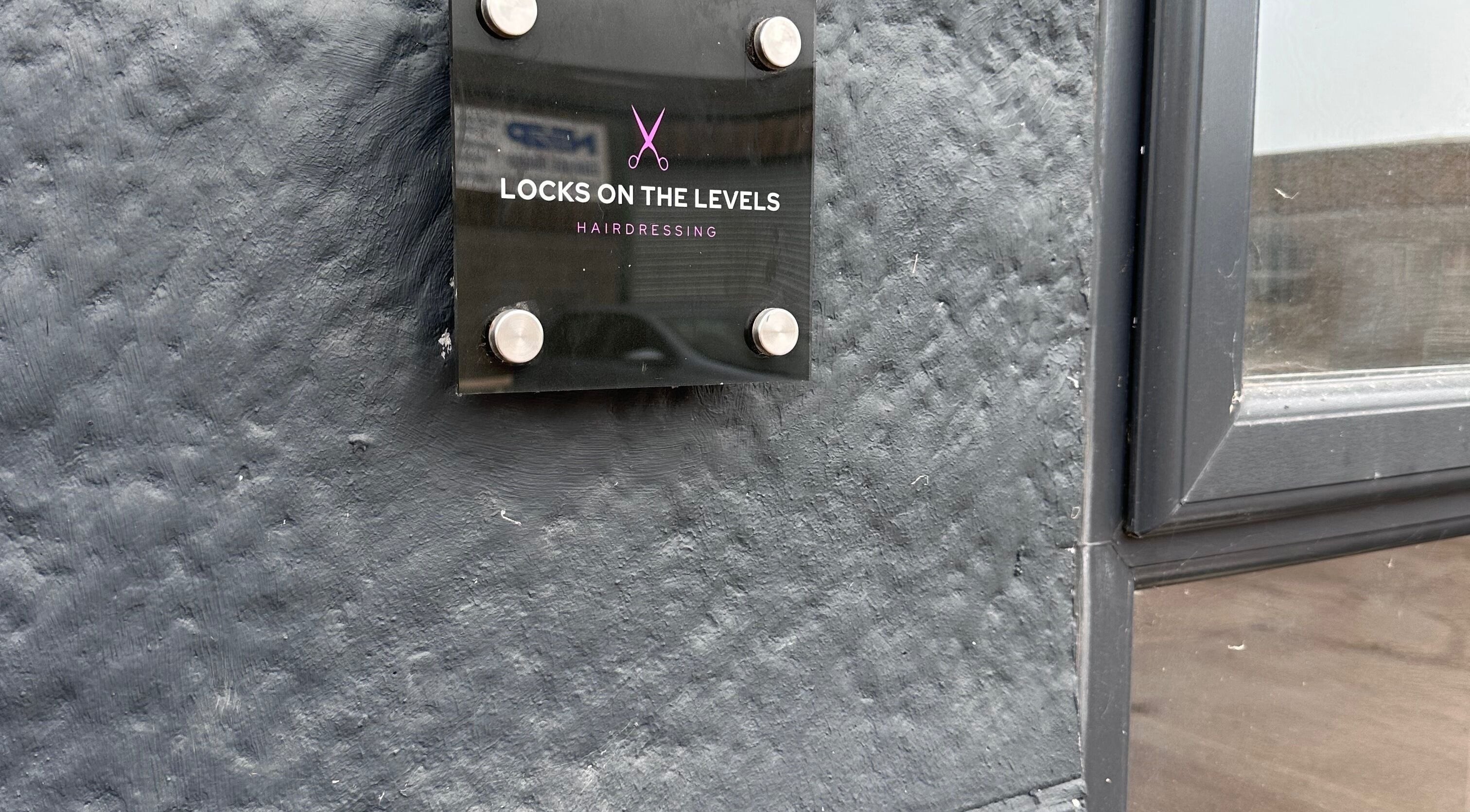 Sign of Locks on the Levels hairdressing salon, Middlezoy, England, GB.