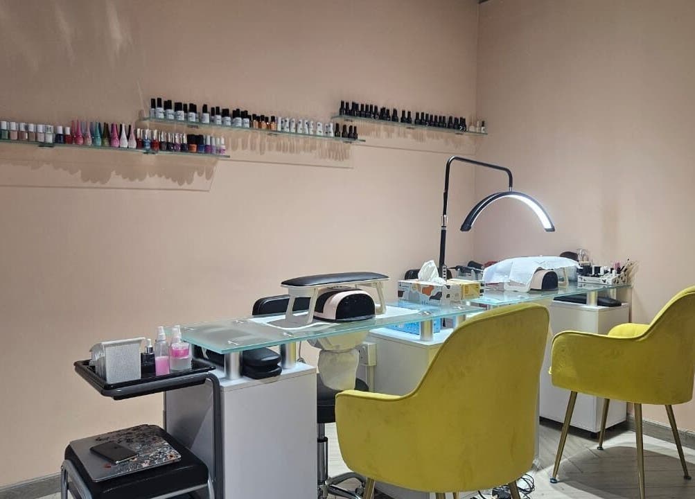 Elegant nail station at Le Merveilleux 99 Salon, Dubai, Dubai, AE with yellow chairs and organized tools.