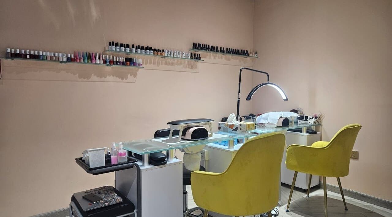 Elegant nail station at Le Merveilleux 99 Salon, Dubai, Dubai, AE with yellow chairs and organized tools.