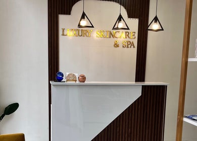 Reception area at Luxury Skincare & Spa in Pretoria, Gauteng, ZA with modern decor and warm lighting.