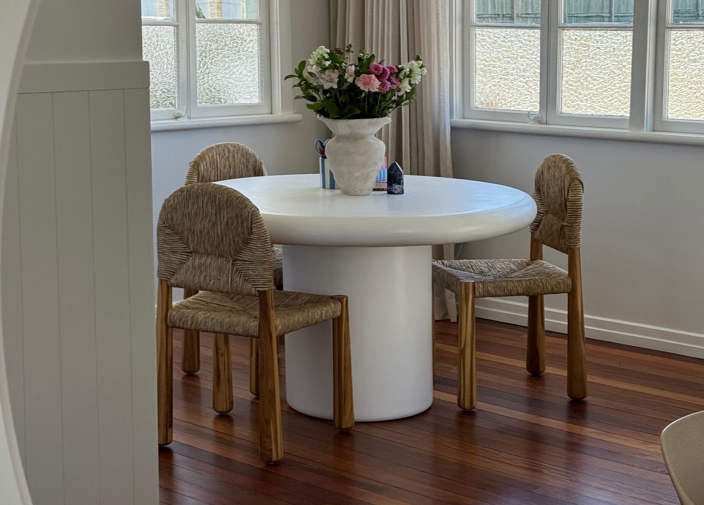 Elegant seating area at Sundae Hair in Caloundra, Queensland, AU with a round table and floral centerpiece.