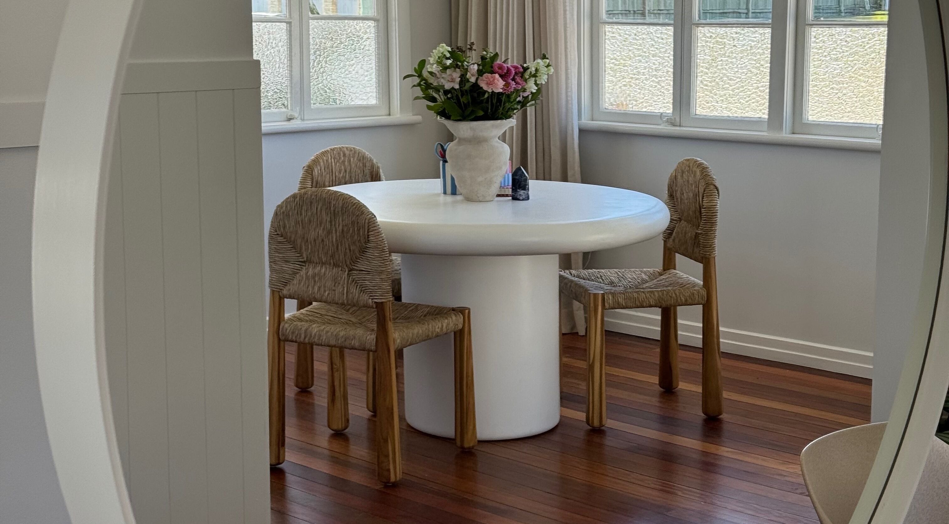 Elegant seating area at Sundae Hair in Caloundra, Queensland, AU with a round table and floral centerpiece.