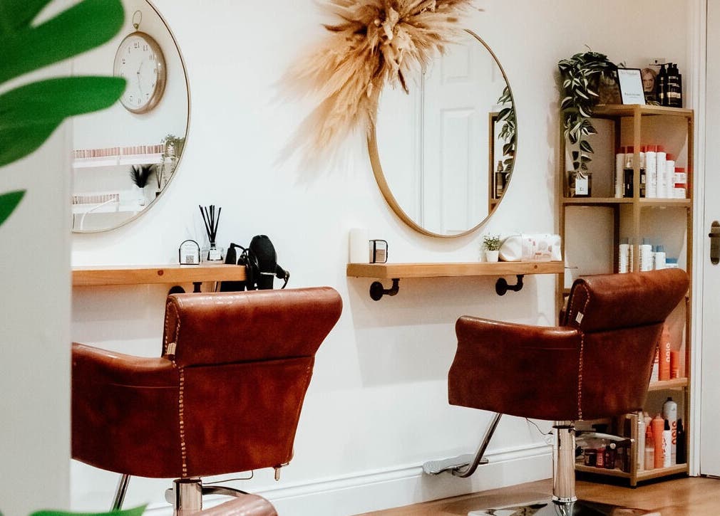 Elegant salon interior at Ivy Studios in Ripley, England, GB, showcasing stylish chairs and beauty products.