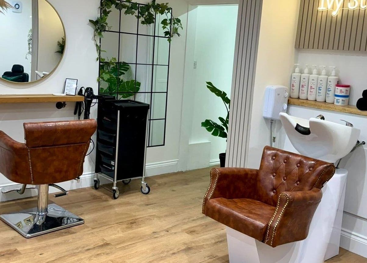 Elegant salon interior at Ivy Studios, Ripley, England, GB, featuring leather chairs and modern decor.