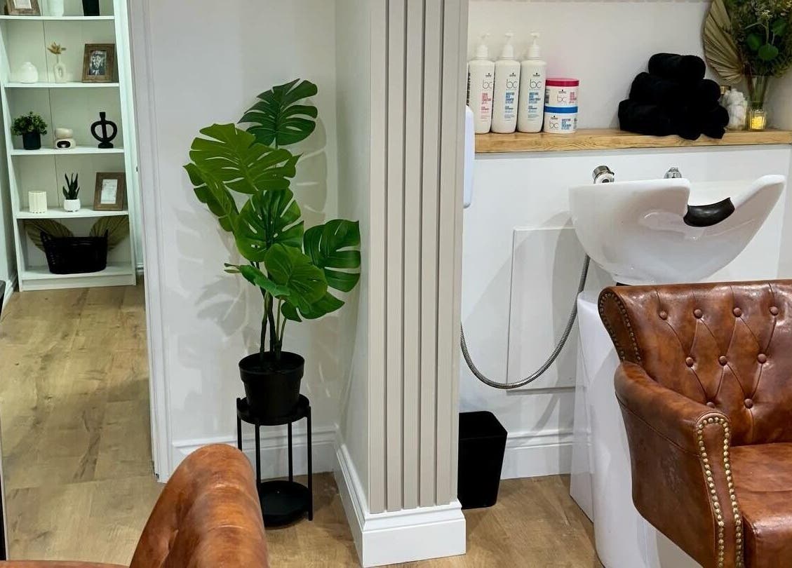 Luxurious hair salon chair and wash station at Ivy Studios in Ripley, England, GB with stylish decor.