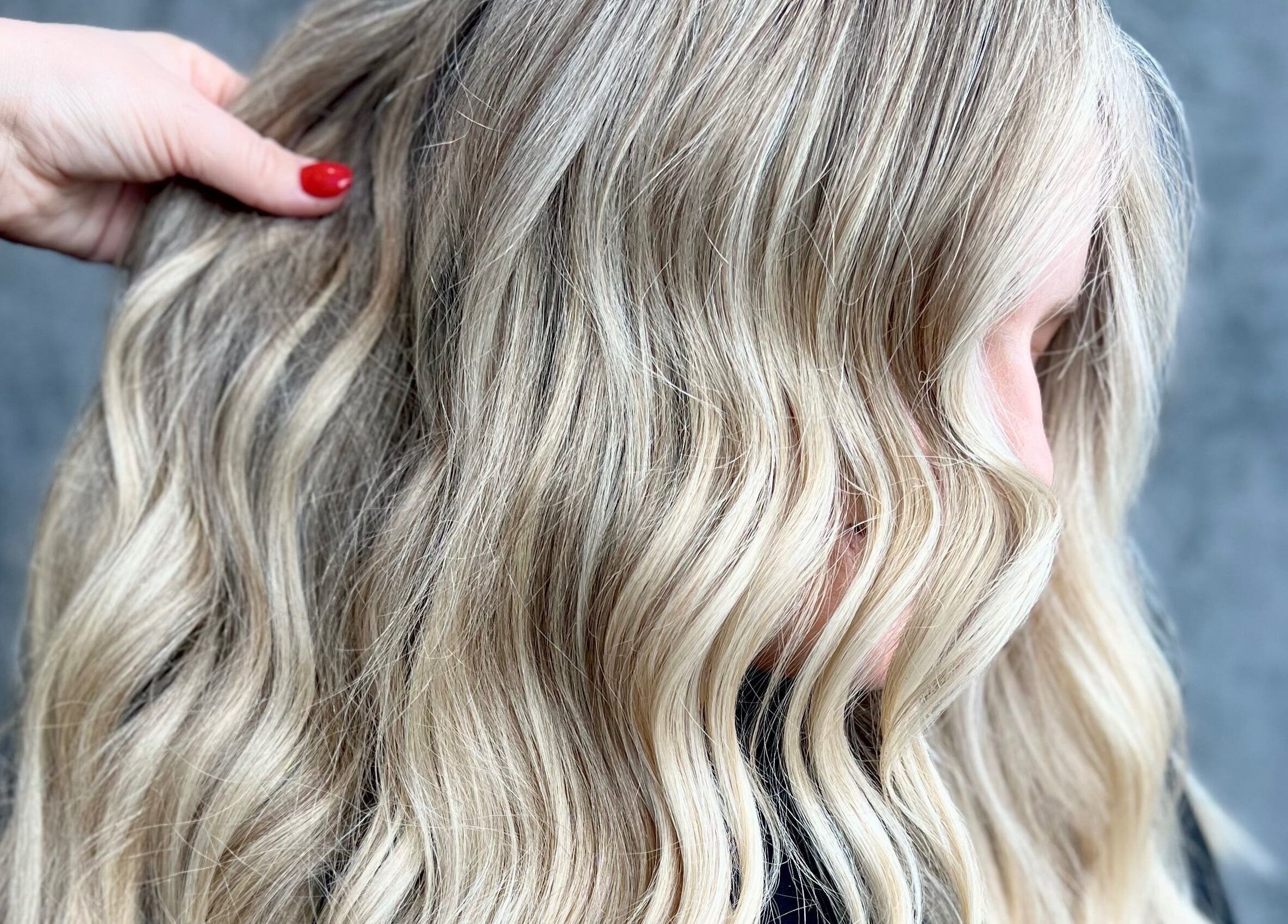 Beautiful blonde wavy hair at Ivy Studios, Ripley, England, GB. Expert styling with precision and care.