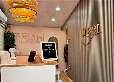Welcoming interior of Treet Day Spa in Arima, Arima Borough Corporation, TT, featuring cozy decor and elegant lighting.
