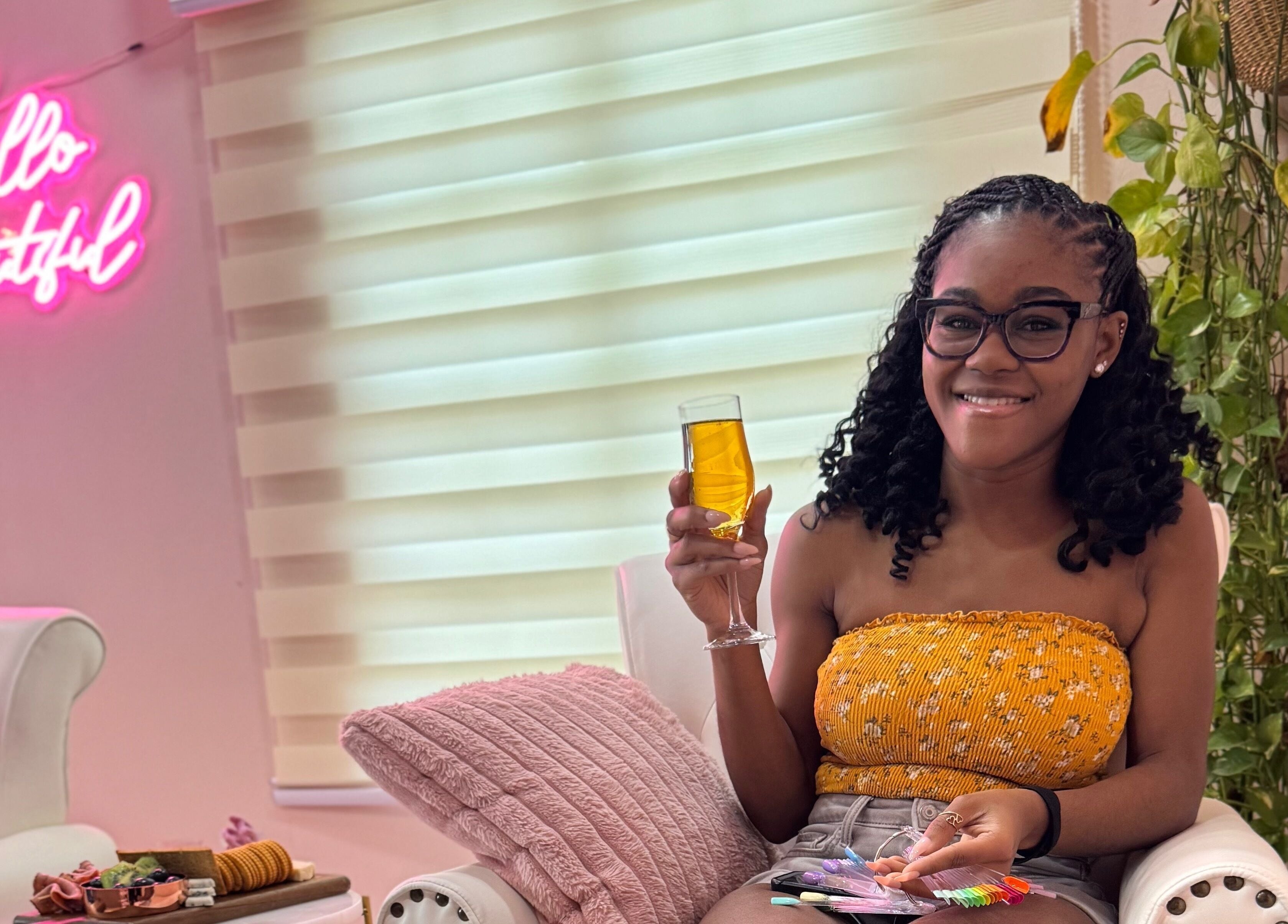 Woman enjoying a drink at Treet Day Spa, Arima, with vibrant decor and plants in Arima Borough Corporation, TT.
