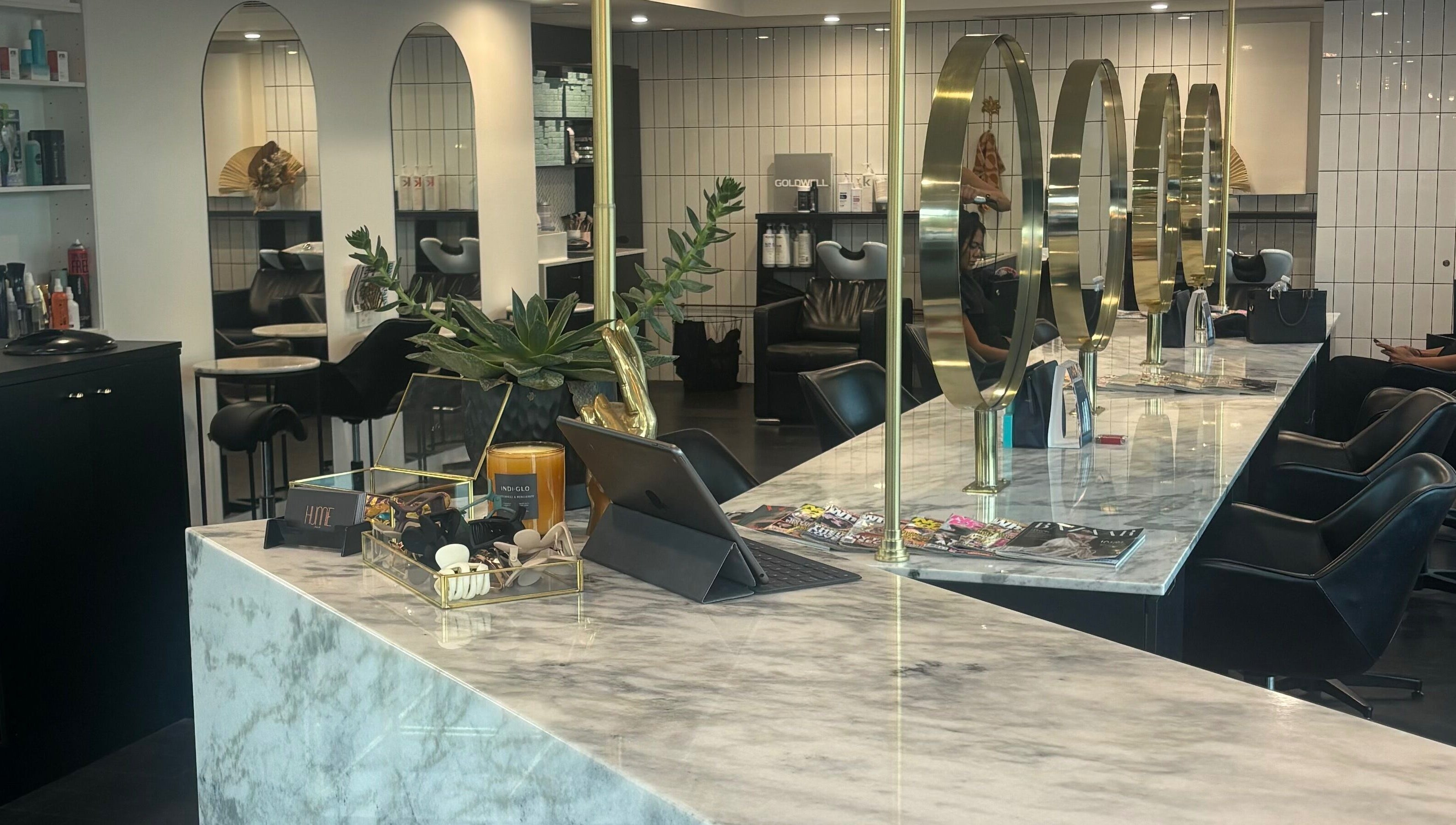 Elegant styling area at Hair by Carlene Jo, Scarborough, Western Australia, AU, showcasing marble counters and mirrors.