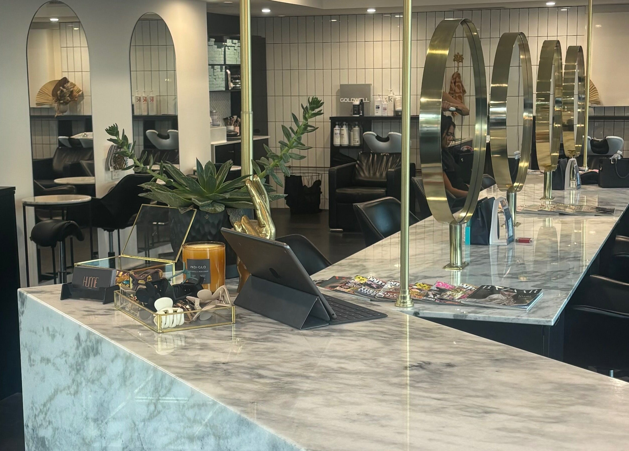 Elegant styling area at Hair by Carlene Jo, Scarborough, Western Australia, AU, showcasing marble counters and mirrors.
