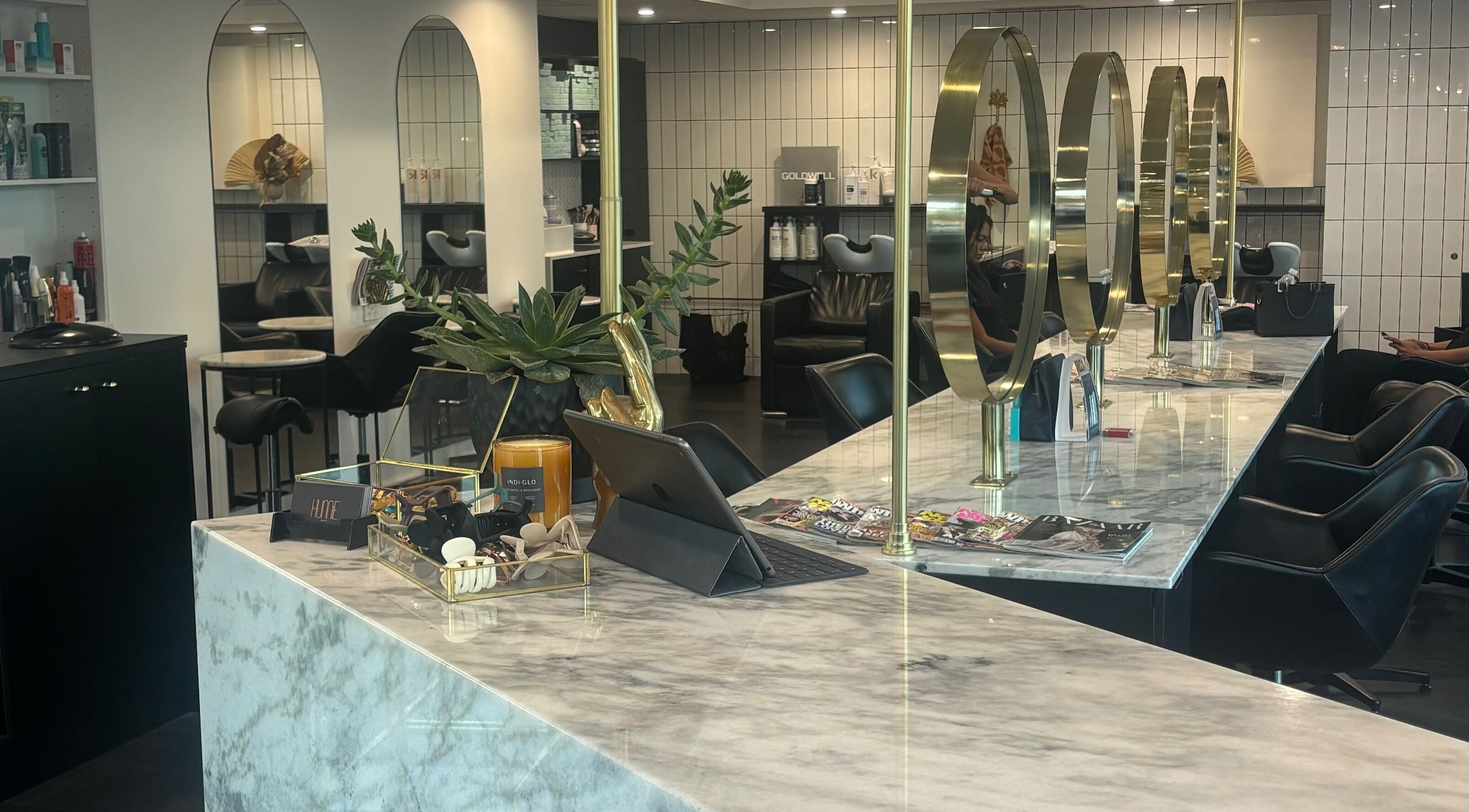 Elegant styling area at Hair by Carlene Jo, Scarborough, Western Australia, AU, showcasing marble counters and mirrors.