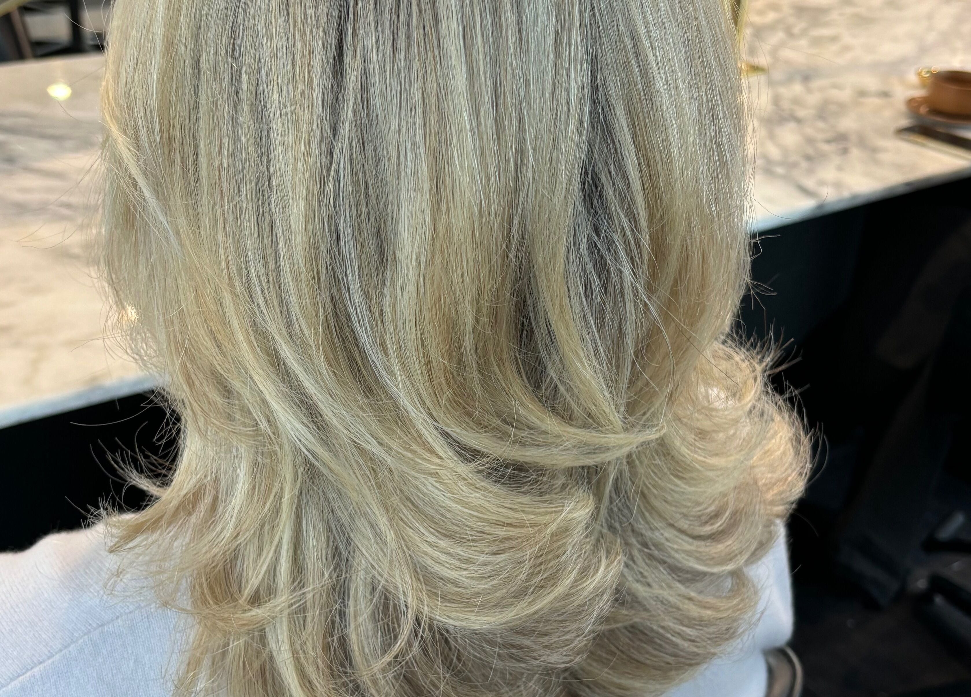 Styled blonde hair at Hair by Carlene Jo, Scarborough, Western Australia, AU showcasing beautiful layers.