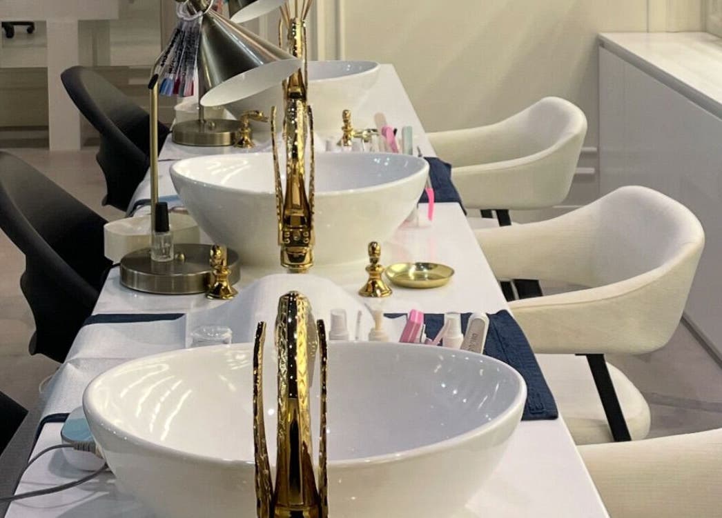 Elegant nail stations at Baran Nail Bar, Seeb, Muscat Governorate, OM, featuring plush chairs and gold accents.