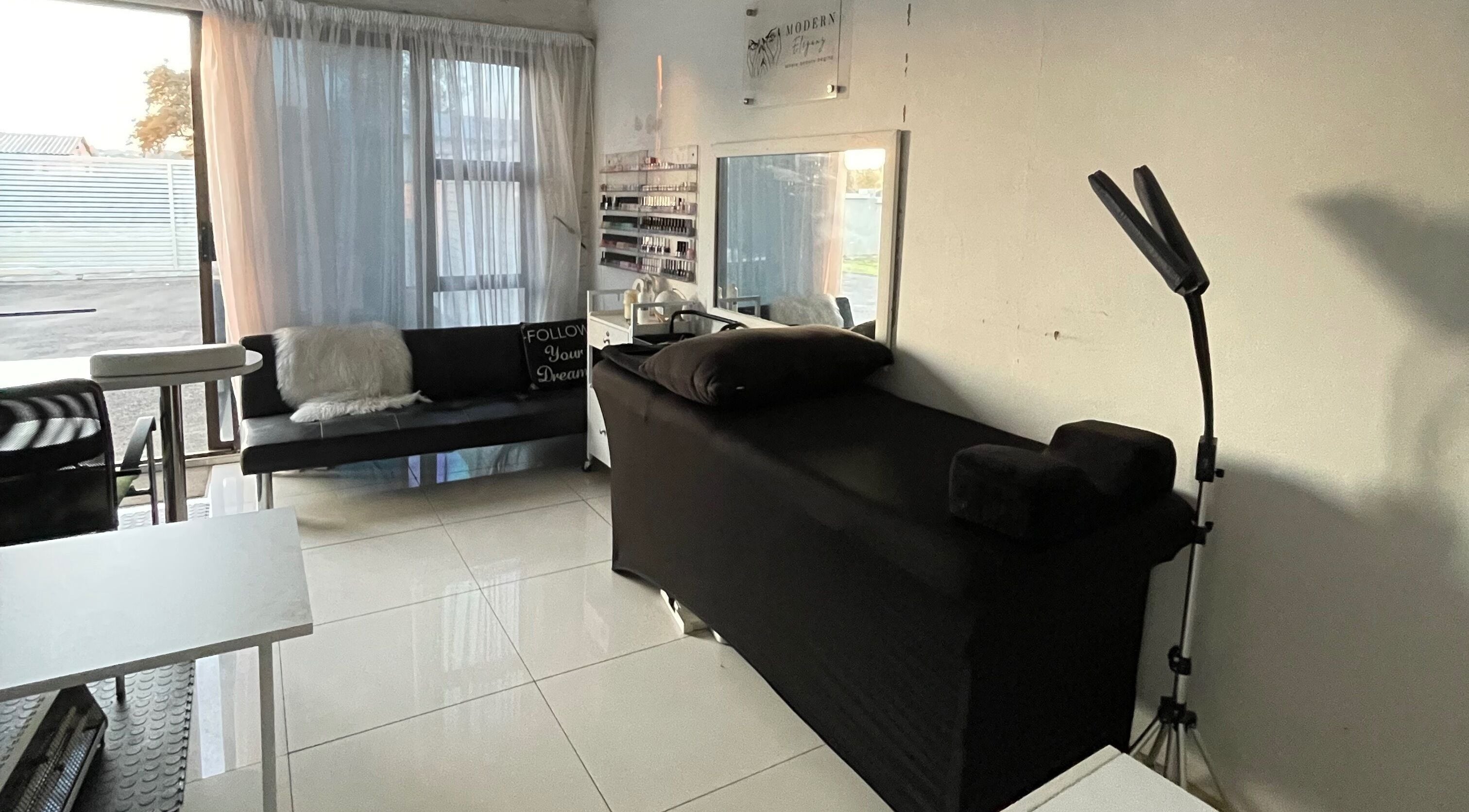 Modern Eleganz beauty room with black treatment bed and natural light, Soweto, Gauteng, ZA.