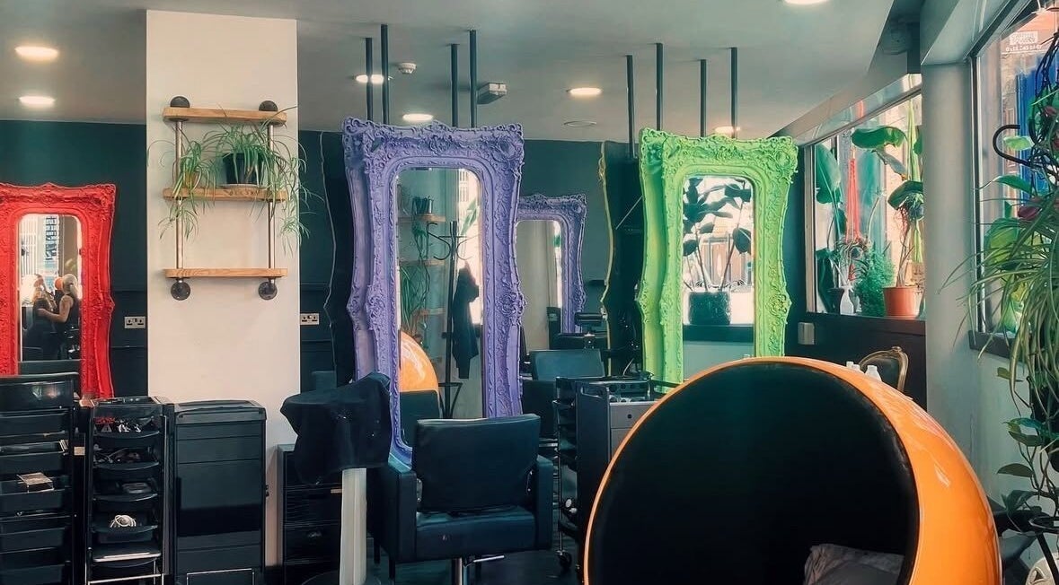 Vibrant mirrors at The Hair Healer salon in Leeds, England, GB create a colorful and inviting atmosphere.