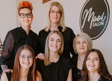 Mooi Salon team posing with smiles in Bloemfontein, Free State, ZA. Professional stylists ready to serve.