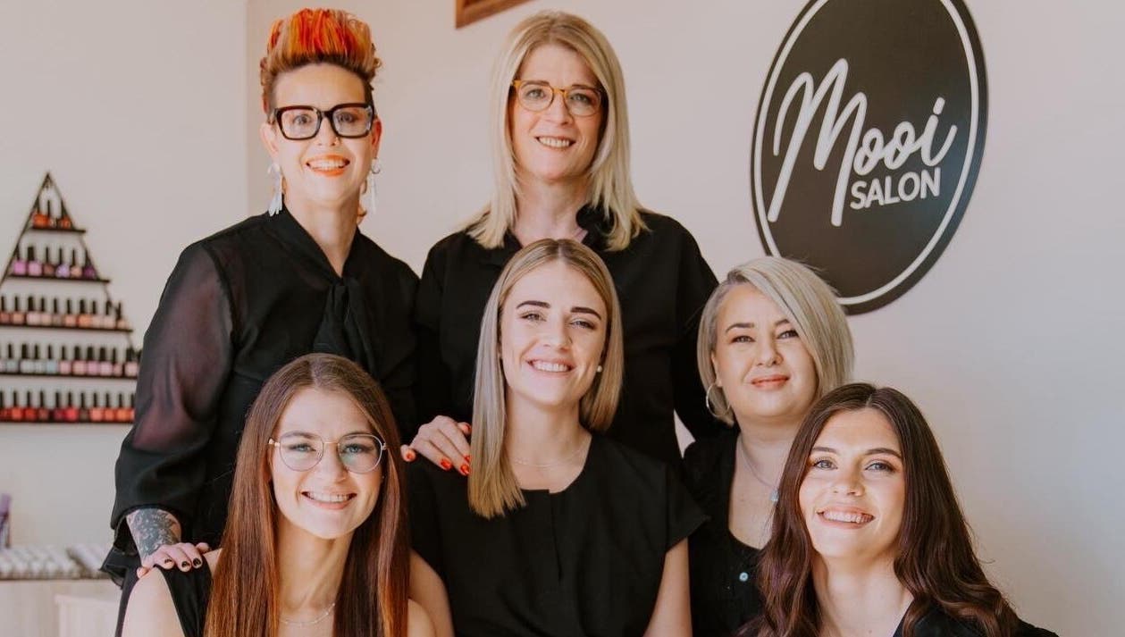 Friendly team of stylists at Mooi Salon in Bloemfontein, Free State, ZA, ready to serve clients with expert care.