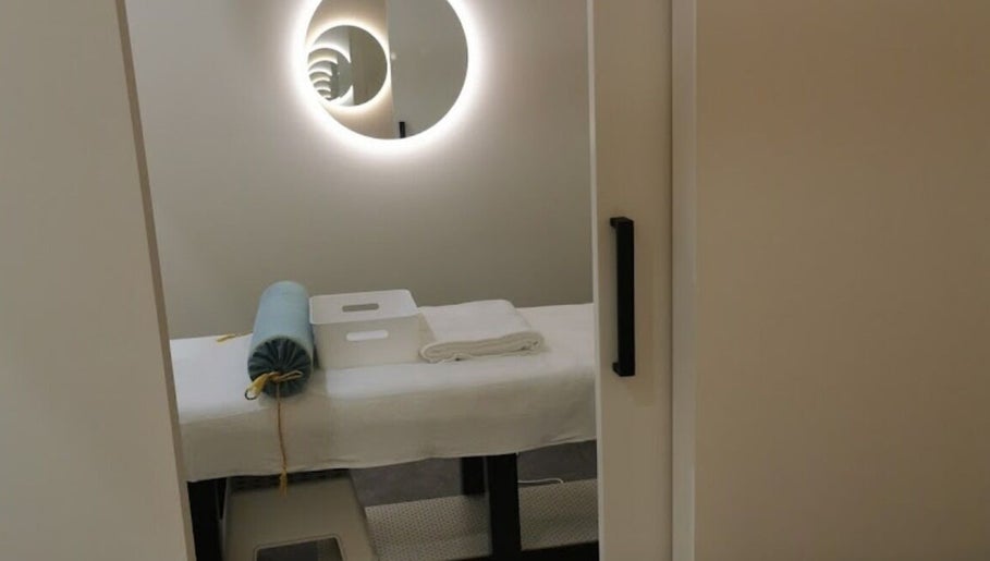 Therapy room at Kang's TCM Clinic in Runaway Bay, Queensland, AU, featuring a massage bed and soothing decor.