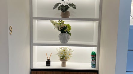 Chic floral arrangements on a modern shelf at Kang’s TCM Clinic, Runaway Bay, Queensland, AU.
