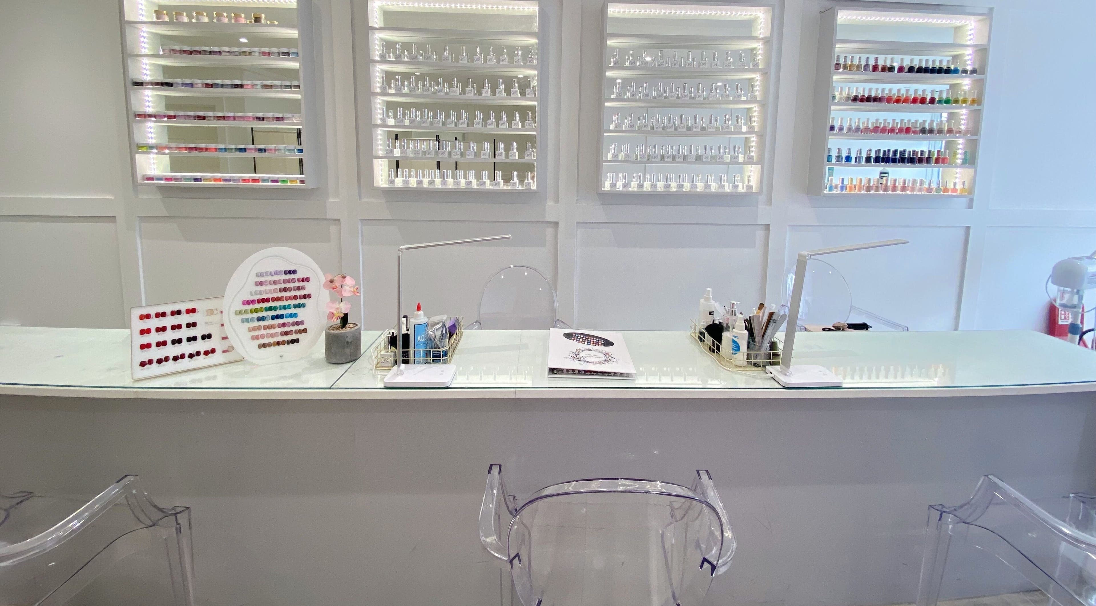Sleek nail bar at Jelly Nails, London, England, GB, showcasing a vibrant nail polish display.