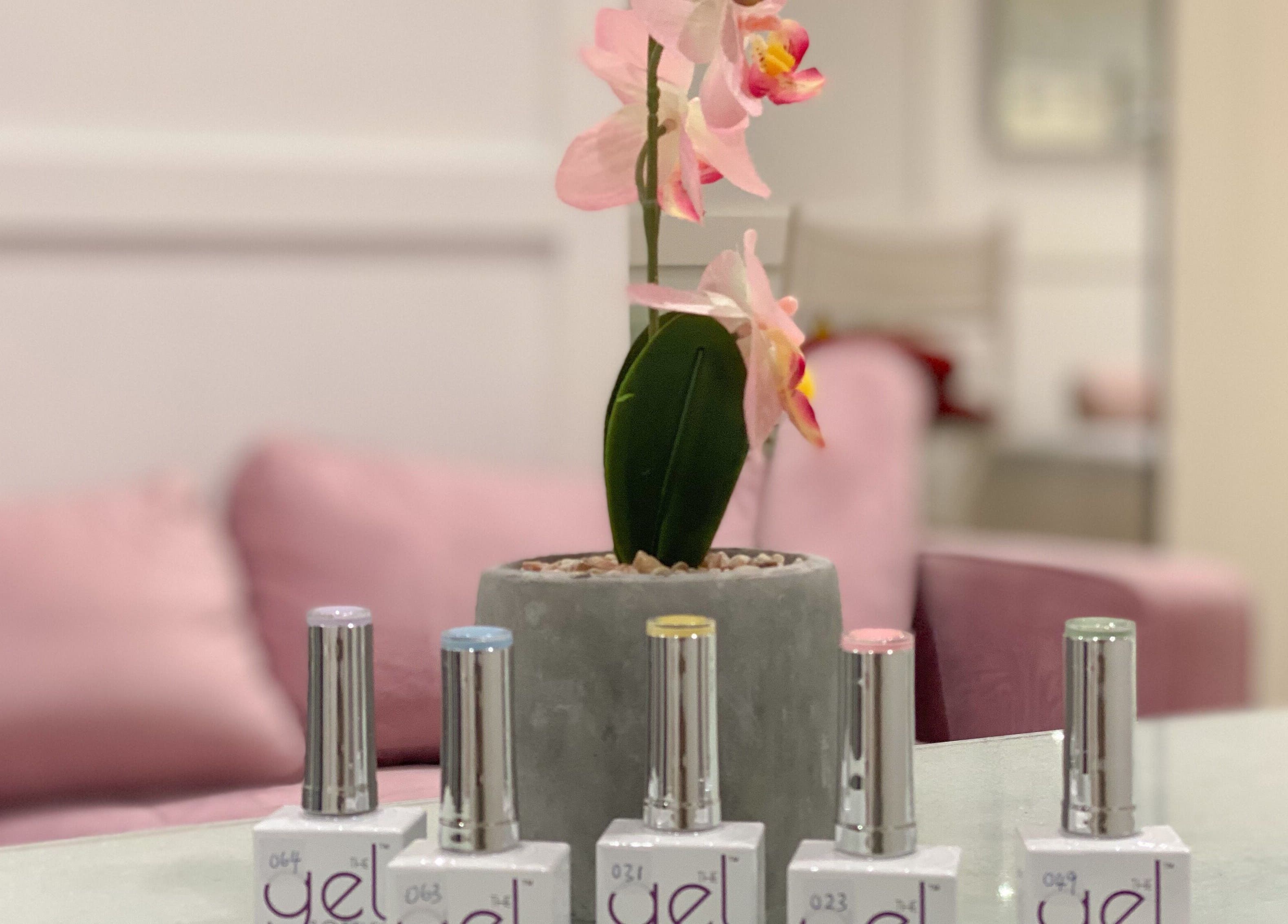 Elegant nail polish and pink orchids at Jelly Nails, London, England, GB, showcasing beauty and style.
