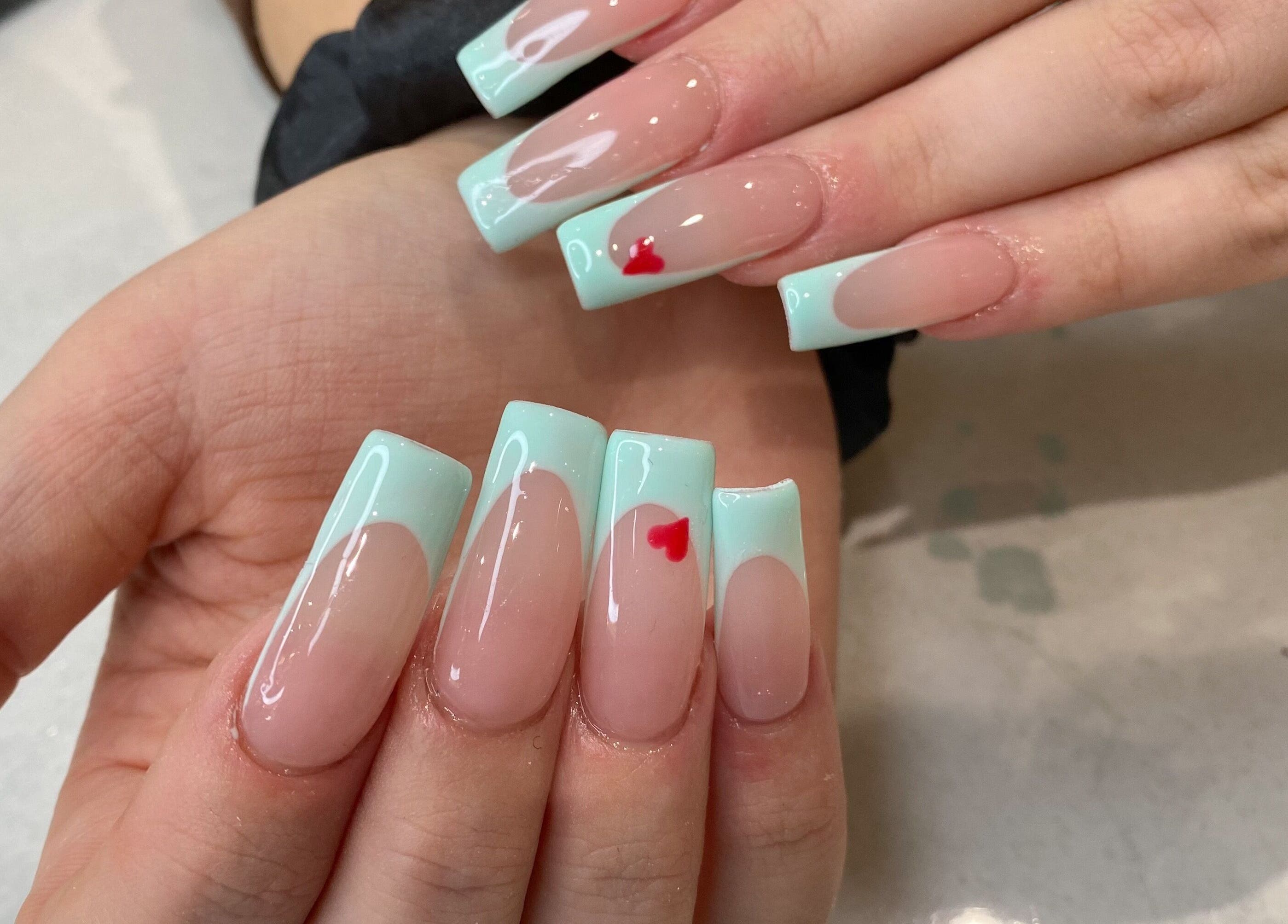 Stylish mint French manicure with heart design at Jelly Nails in London, England, GB.