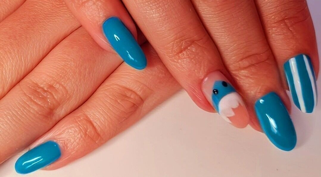 Vibrant blue nails with elegant designs at Magical Nails by Ewa in Spalding, England, GB.