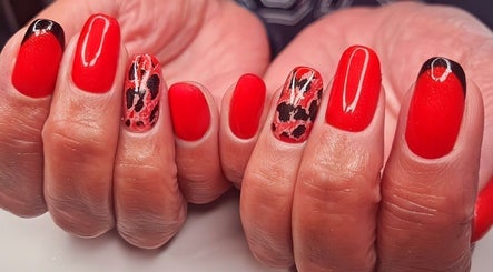 Bright red nails with artistic designs at Magical Nails by Ewa, Spalding, England, GB.