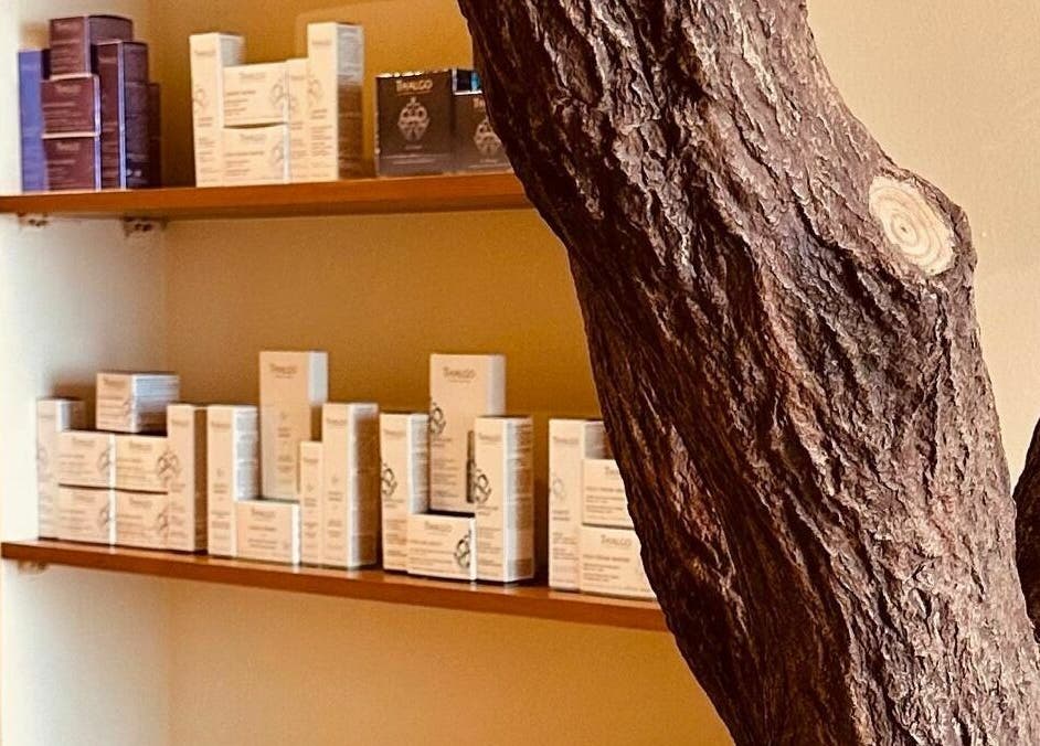 Relaxing interior of Anotha Beauty Salon, Dubai, AE, with skincare products elegantly displayed on shelves.