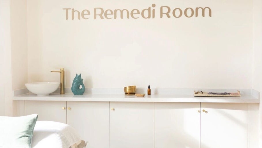 Calm interior at The Remedi Room, Wolverhampton, England with a minimalist white counter and gold faucet.