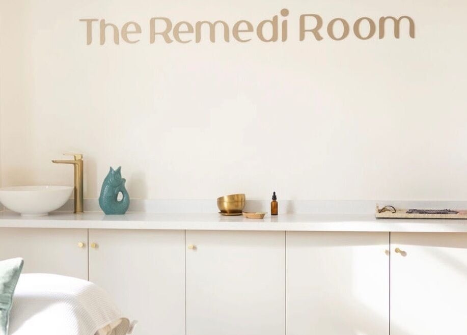 Calm interior at The Remedi Room, Wolverhampton, England with a minimalist white counter and gold faucet.
