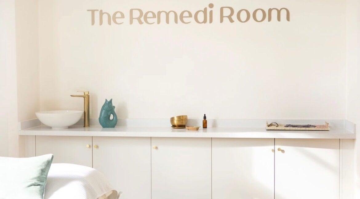 Calm interior at The Remedi Room, Wolverhampton, England with a minimalist white counter and gold faucet.