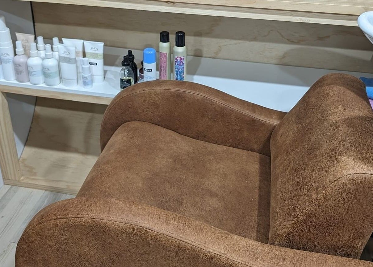 Comfortable salon chair at Hair NV by Jade, Heathridge, Western Australia, AU with beauty products displayed nearby.