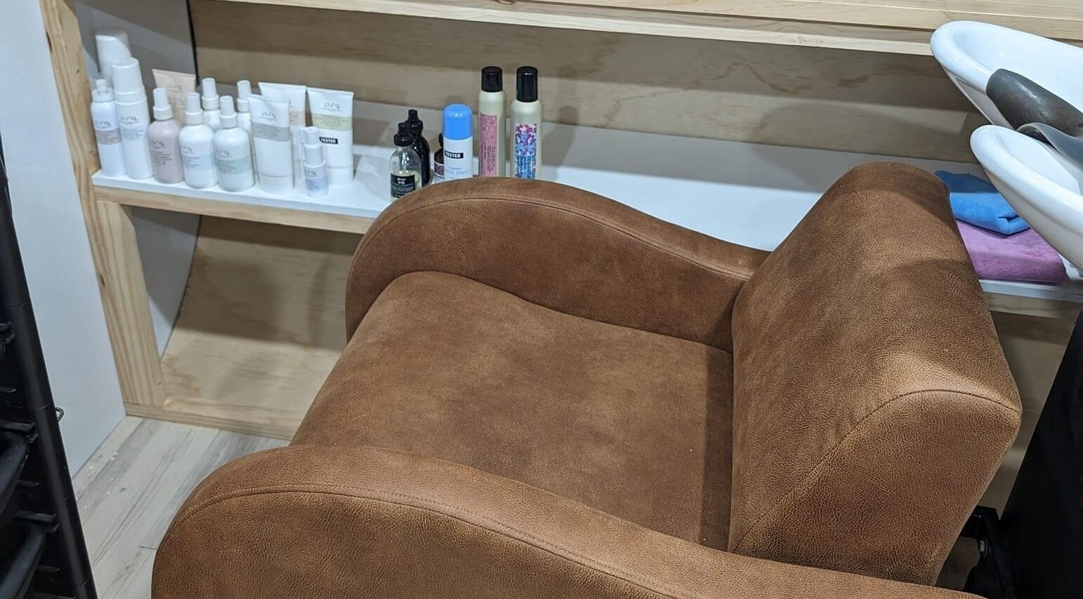 Comfortable salon chair at Hair NV by Jade, Heathridge, Western Australia, AU with beauty products displayed nearby.