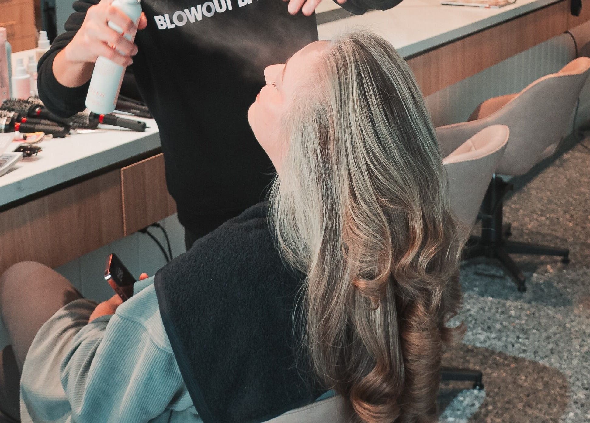 Woman receiving stylish blowout at The Blowout Bar - Brighton, Brighton, Victoria, AU.