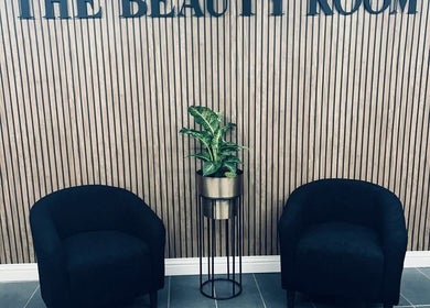 Modern waiting area at Lyndsey Dunning Hair at The Beauty Room, Malton, England, GB with sleek chairs and a plant.