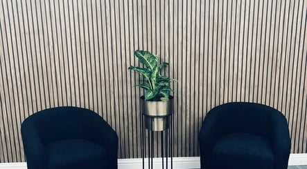 Modern waiting area at Lyndsey Dunning Hair at The Beauty Room, Malton, England, GB with sleek chairs and a plant.