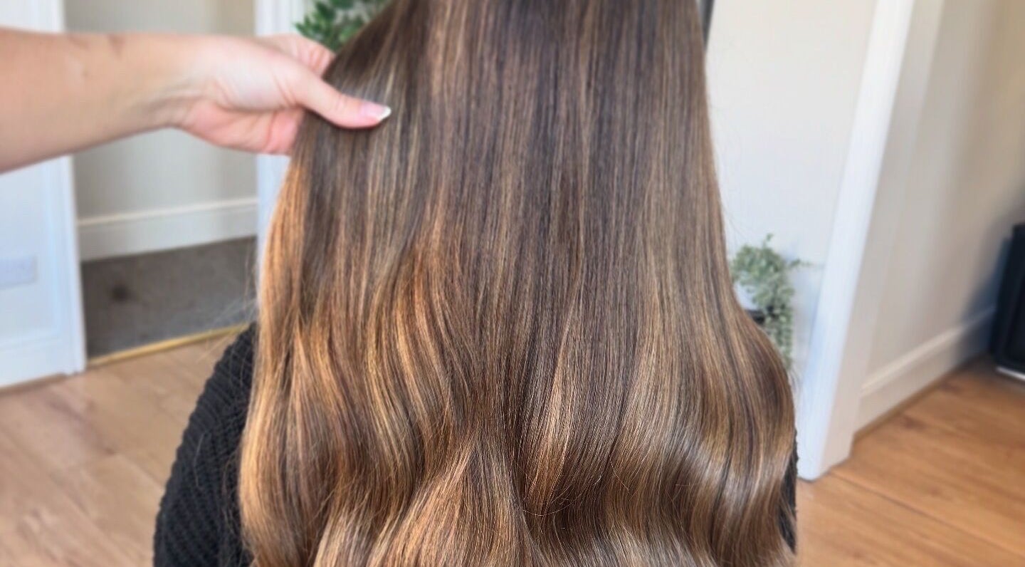 Glossy brown hair styled at DE Hair & Aesthetics, Kingsteignton, England, GB.