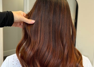 Shiny brunette waves styled at DE Hair & Aesthetics, Kingsteignton, England, GB. Luxurious salon finish.