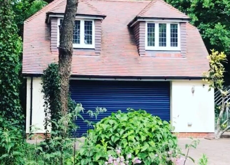 Front view of Worthing Clinic with Nurse Rebecca in Worthing, England, surrounded by lush greenery.