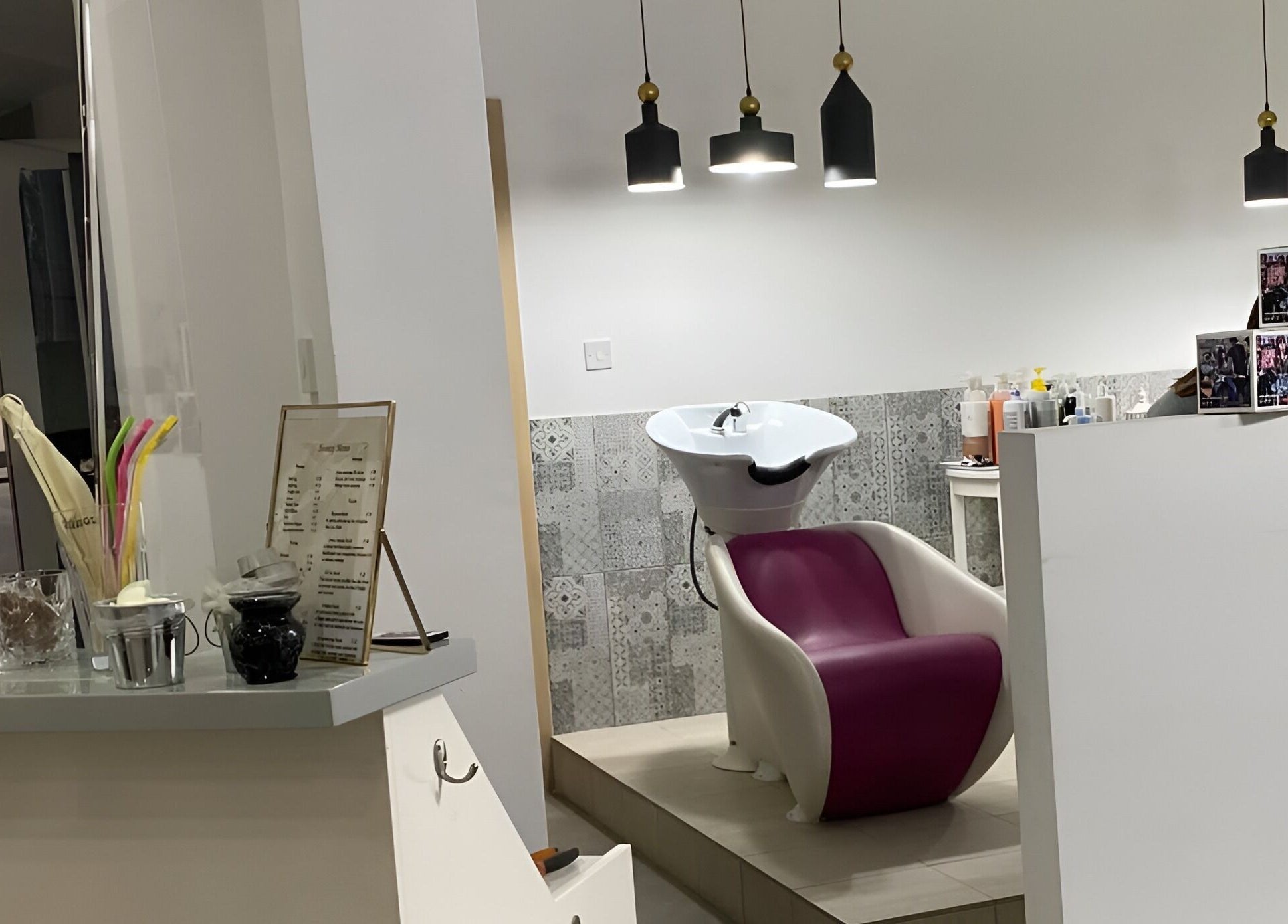 Modern wash station at The Cutting Room, Mandria, Paphos, CY, featuring sleek design and ambient lighting.