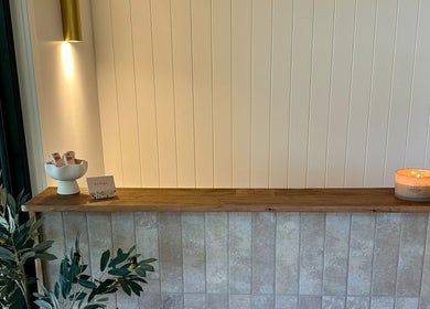 Cozy reception at Divine Beauty House in Charlotte Bay, New South Wales, AU with lit candle and decor.