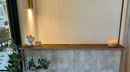 Cozy reception at Divine Beauty House in Charlotte Bay, New South Wales, AU with lit candle and decor.