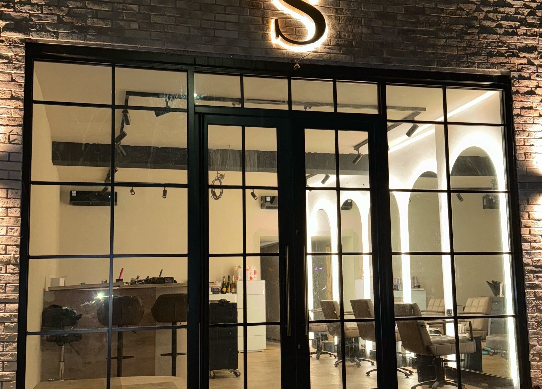 Night view of illuminated Signature Skin facade in Swinton, England, GB, showcasing modern design.