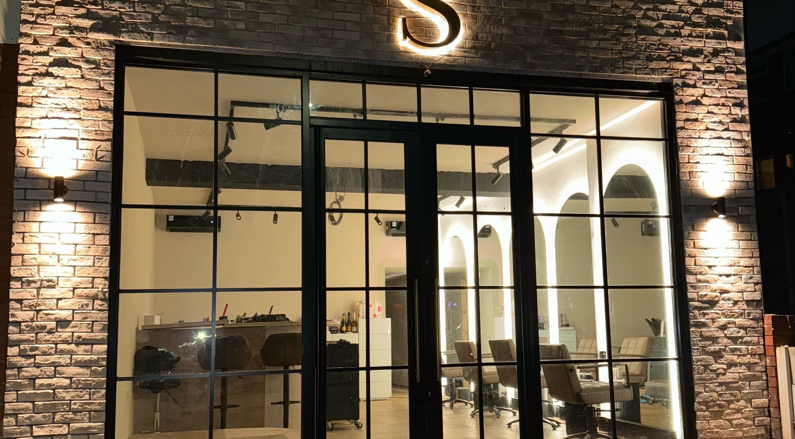 Night view of illuminated Signature Skin facade in Swinton, England, GB, showcasing modern design.