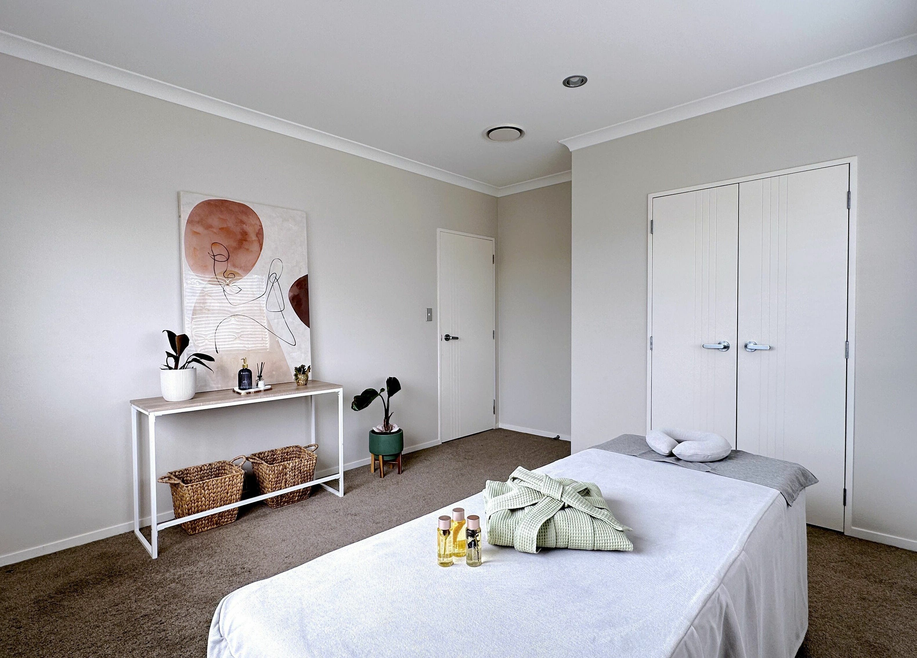 Tranquil massage room at Wellness Massage Silverdale, Silverdale, Auckland, NZ with a massage table and calm decor.