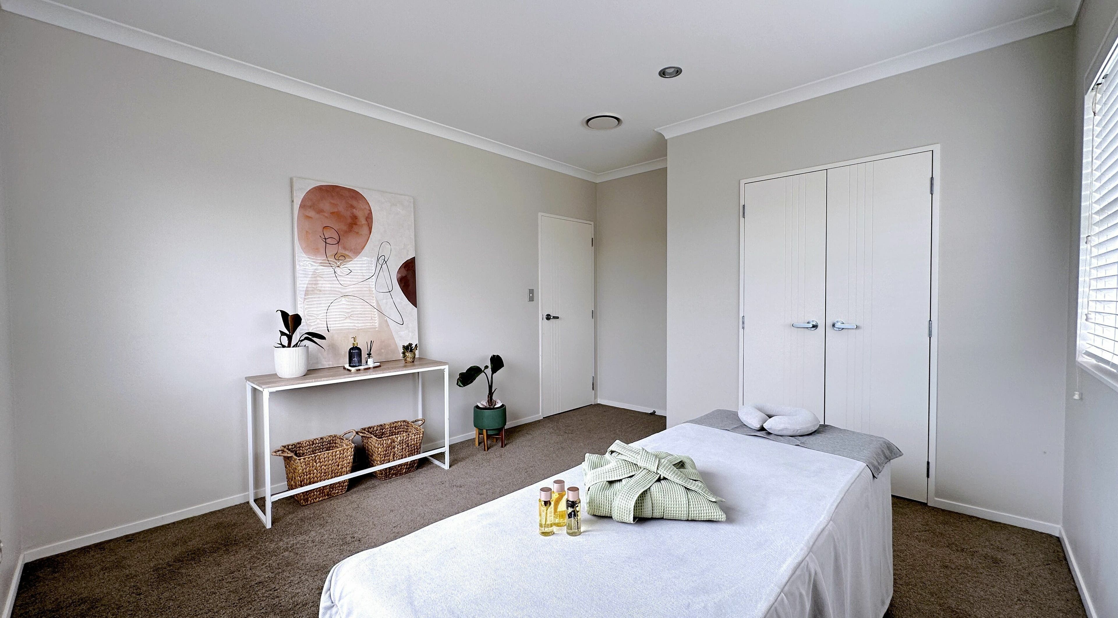 Tranquil massage room at Wellness Massage Silverdale, Silverdale, Auckland, NZ with a massage table and calm decor.