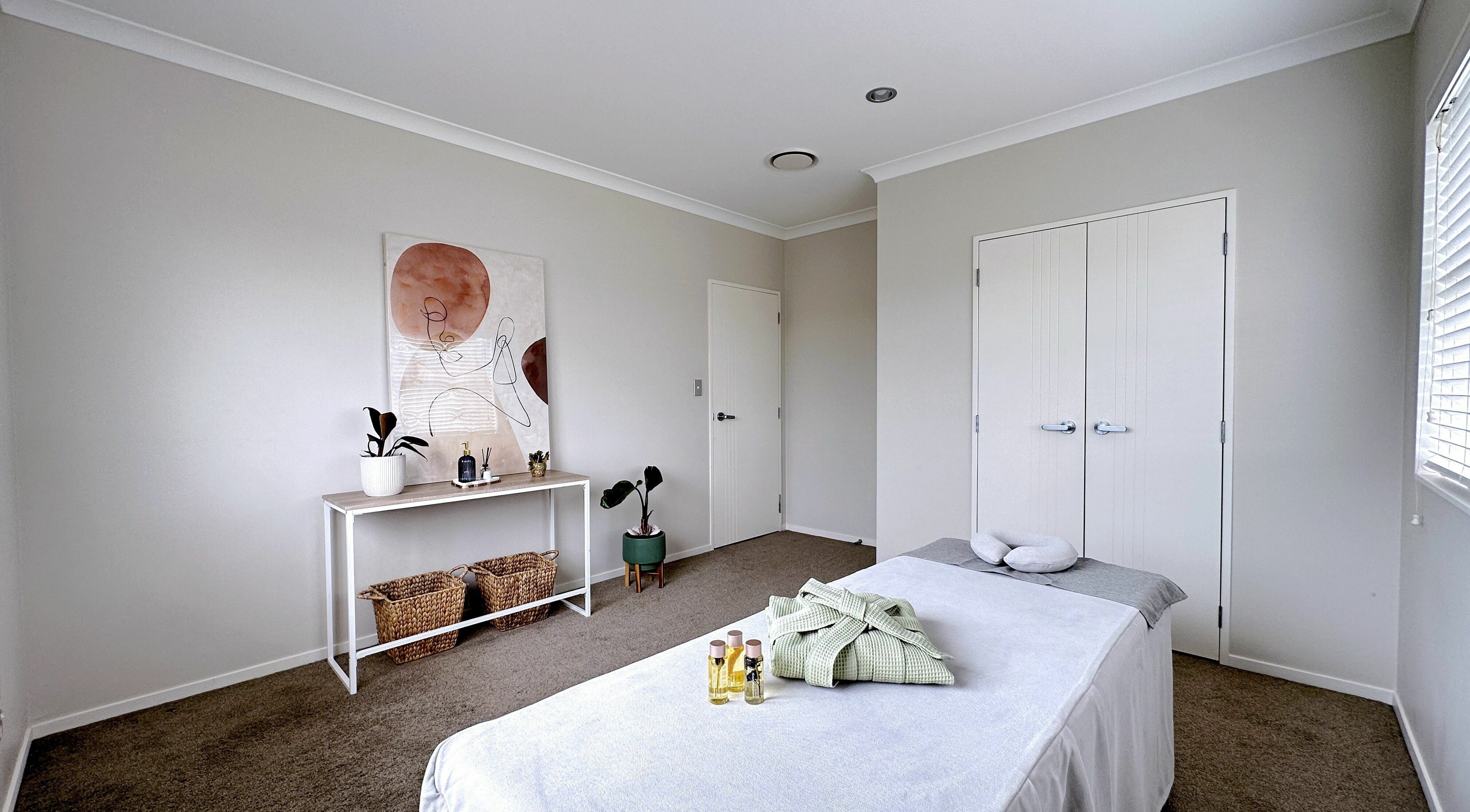 Tranquil massage room at Wellness Massage Silverdale, Silverdale, Auckland, NZ with a massage table and calm decor.