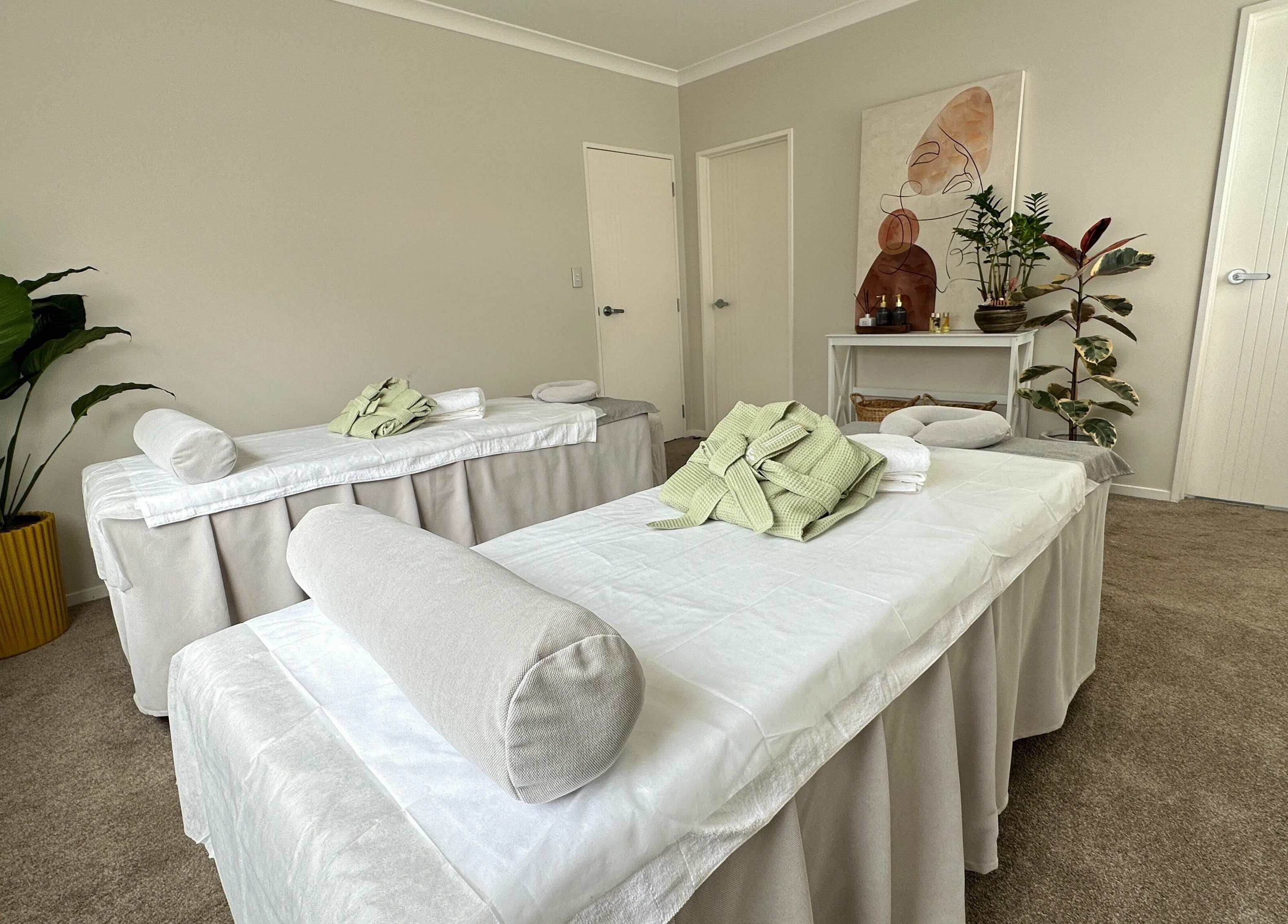 Relaxing massage room at Wellness Massage Silverdale in Silverdale, Auckland, NZ with two massage tables.