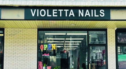 Entrance of Violetta Beauty Studio in White Plains, New York, US, featuring a neon 'Open' sign.